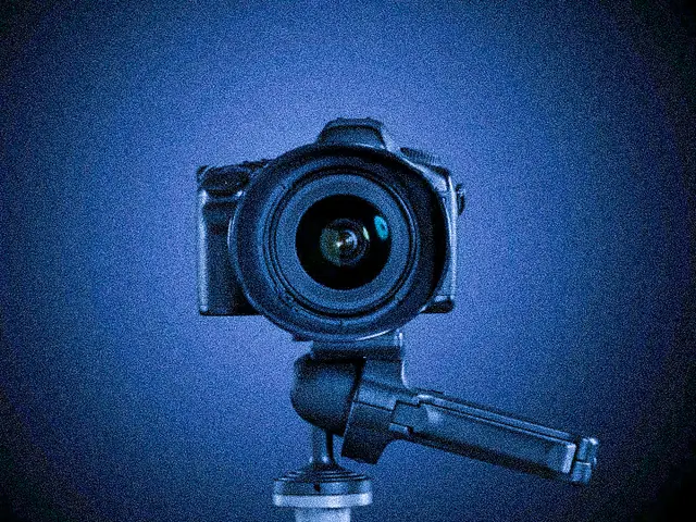 A camera mounted on a tripod facing forward